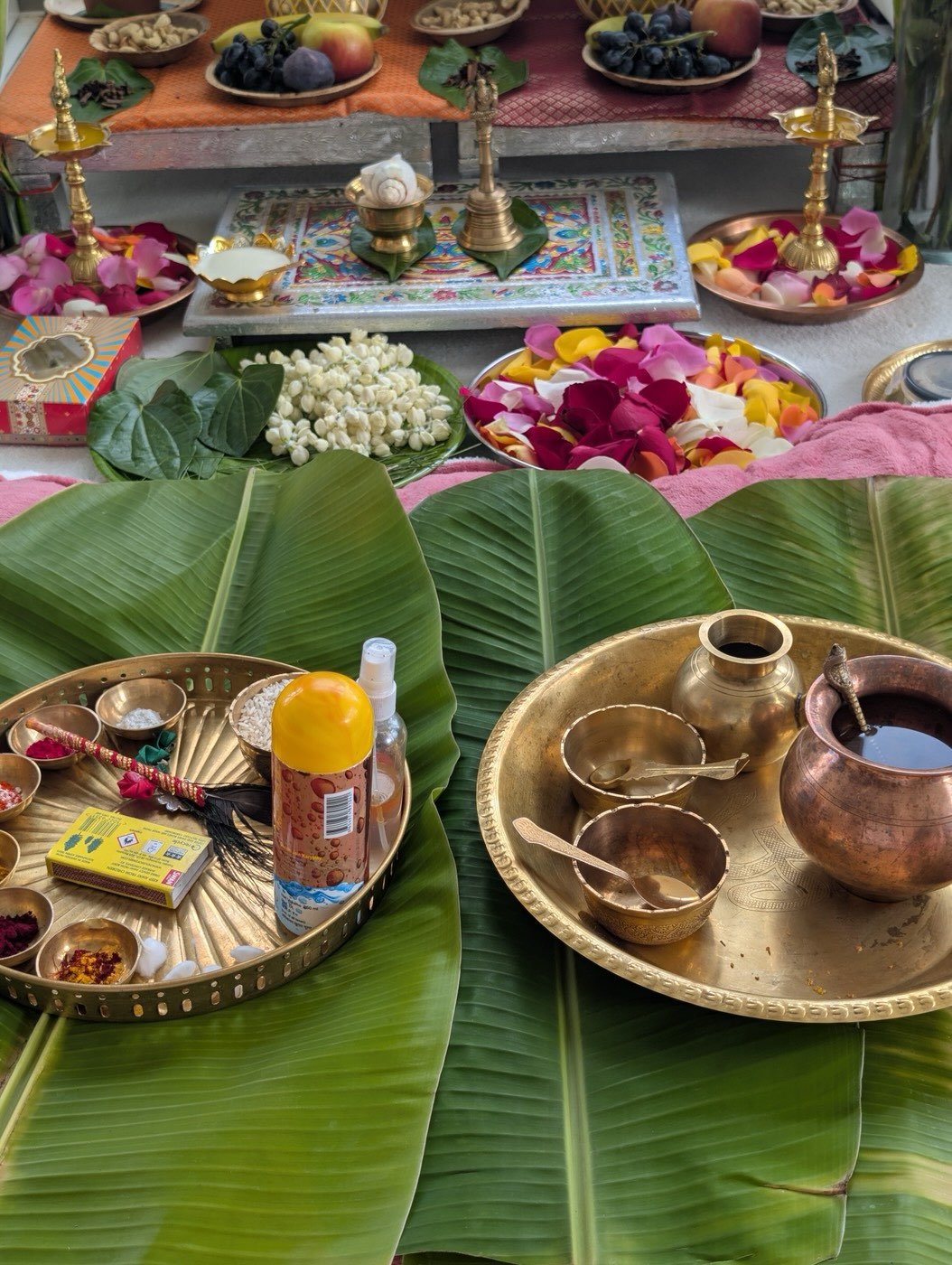 Brass thalis and pots set on banana leaves