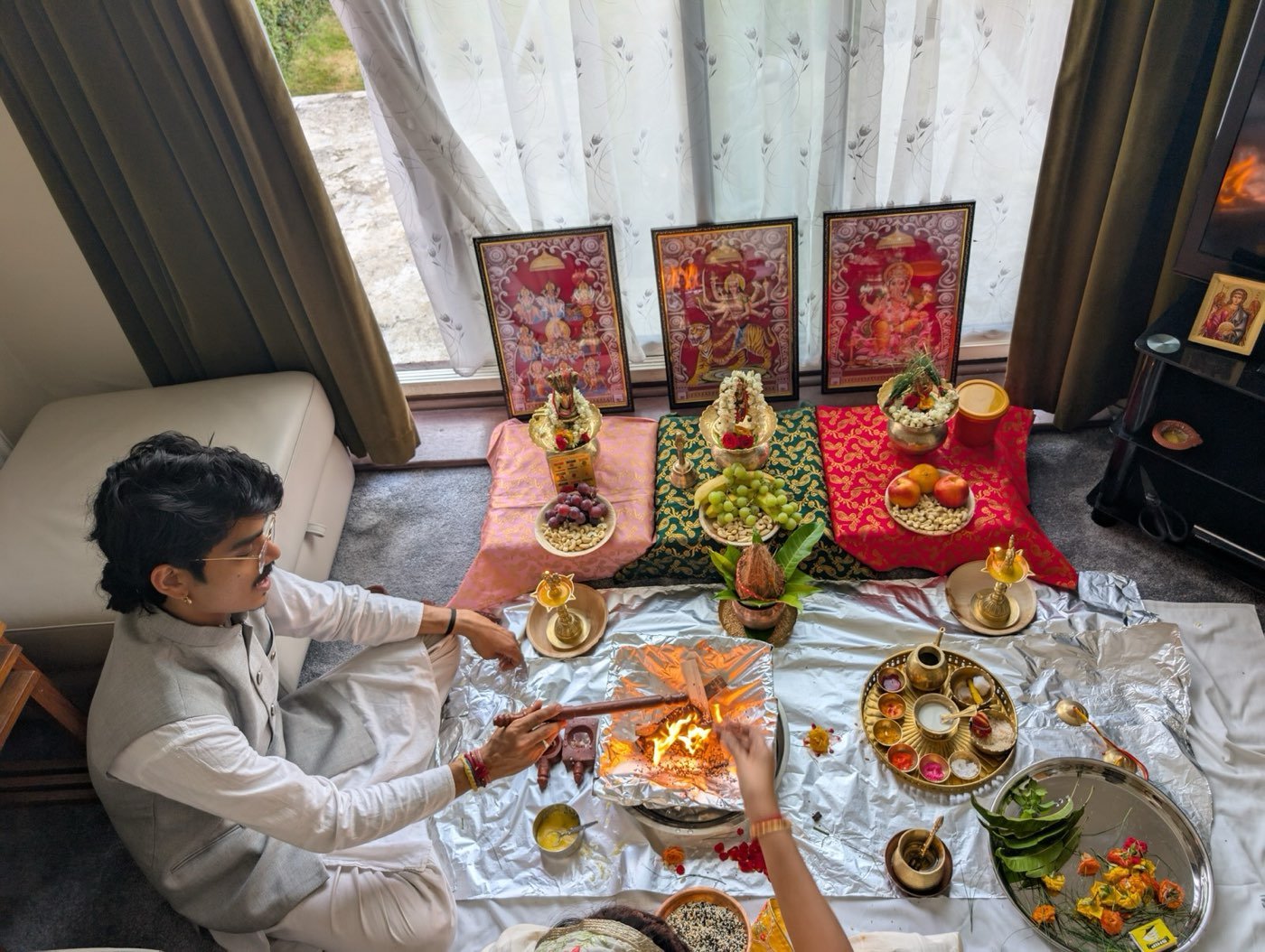 Parth Bhatt performing a puja in a living room by the window