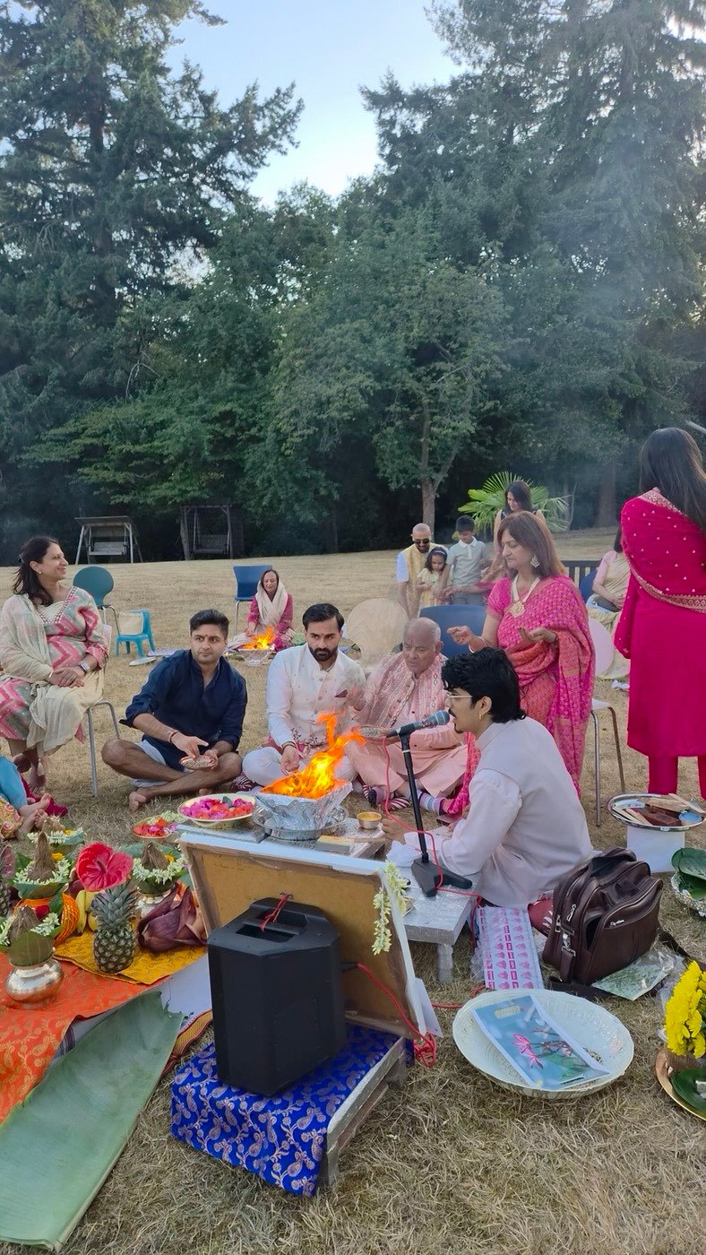 Outdoor havan in a garden with family seated around the fire